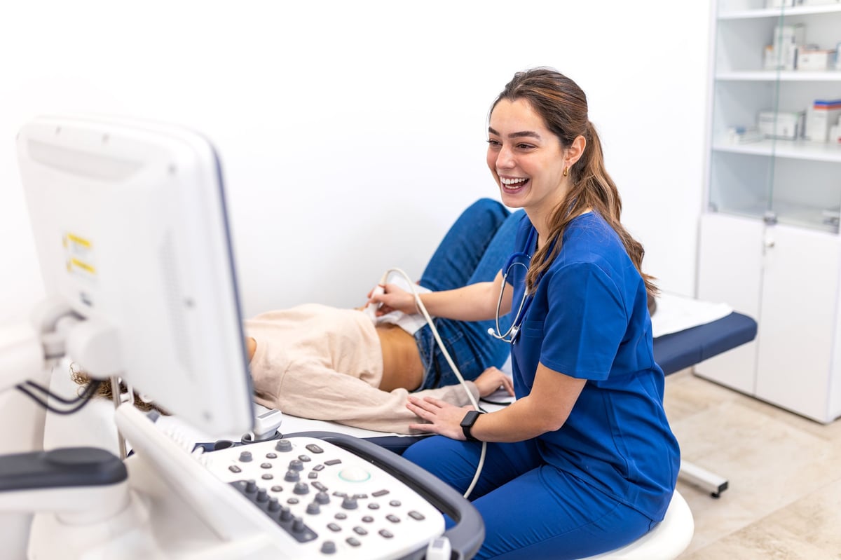 Clinician performing a radiation-free ultrasound diagnostic scan using advanced sonogram equipment