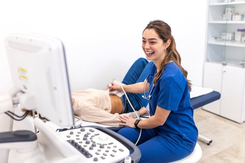 Clinician performing a radiation-free ultrasound diagnostic scan using advanced sonogram equipment